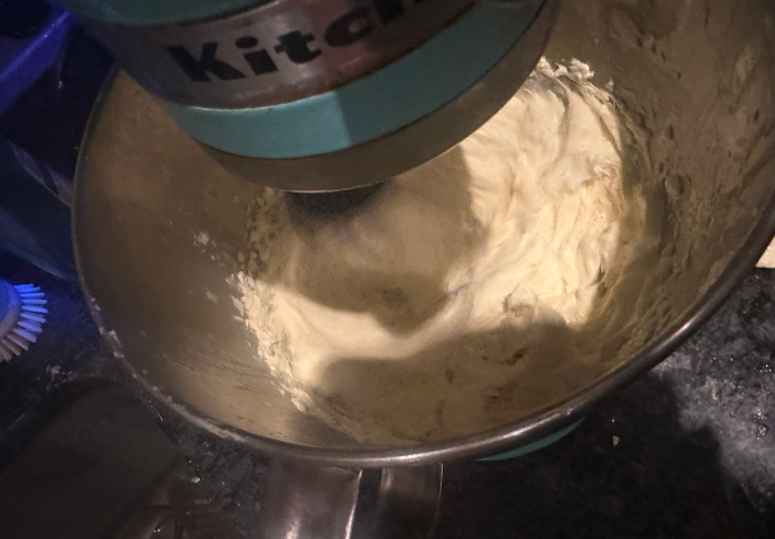 Egg whites in a stand mixer, whipped to stiff peaks.